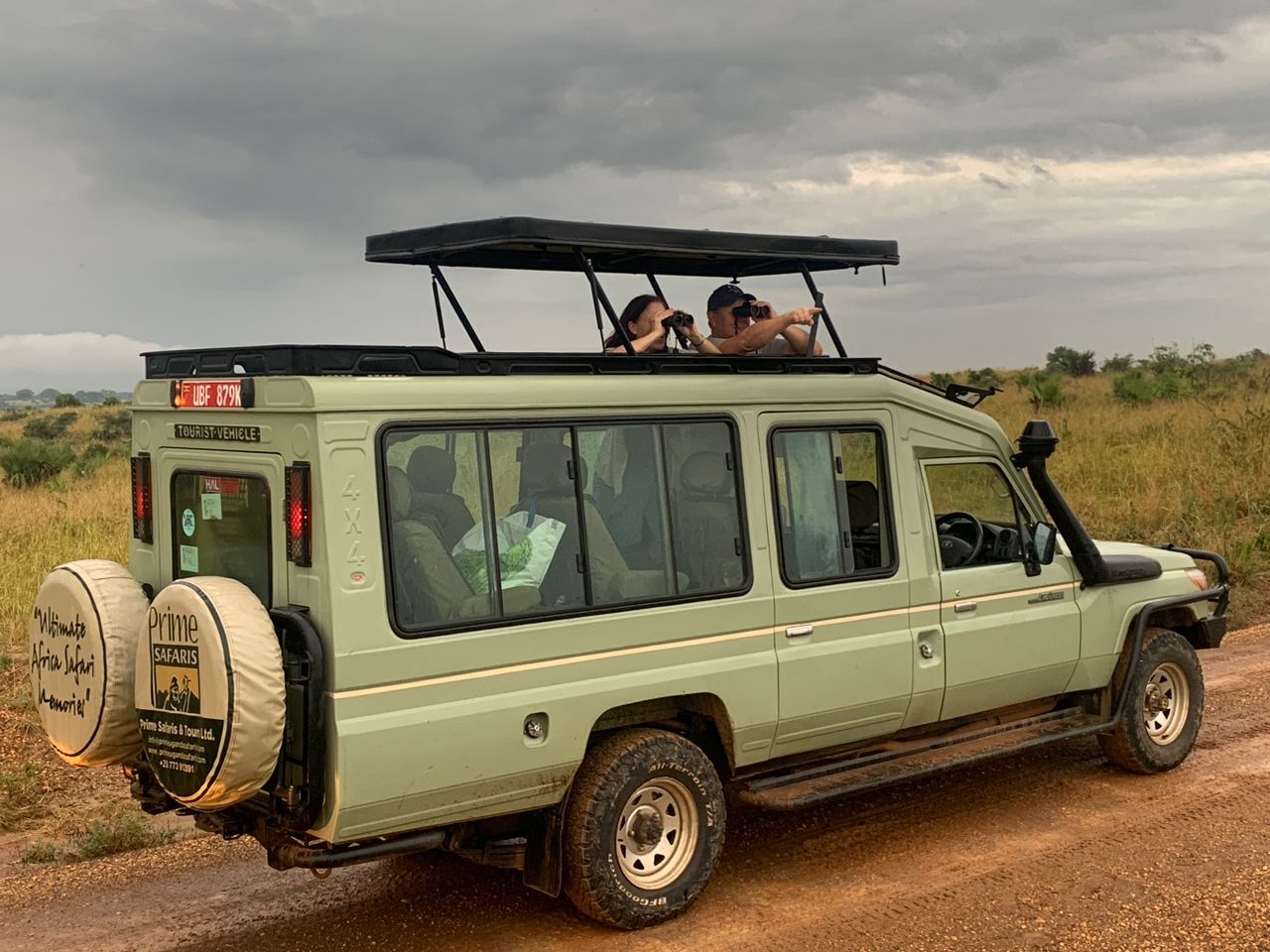 A guide and traveller sharing a moment on a Uganda journey.