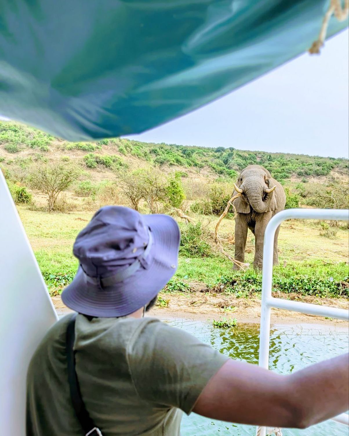 A traveller on a scenic trail through Uganda's wild landscape.